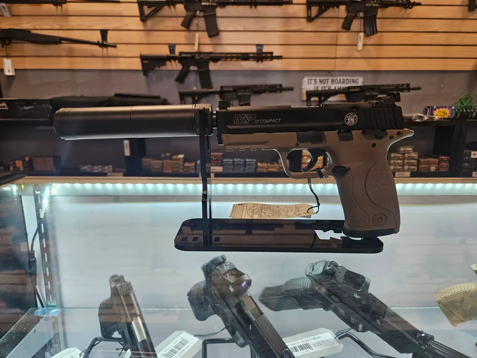 Pistol with a suppressor on display